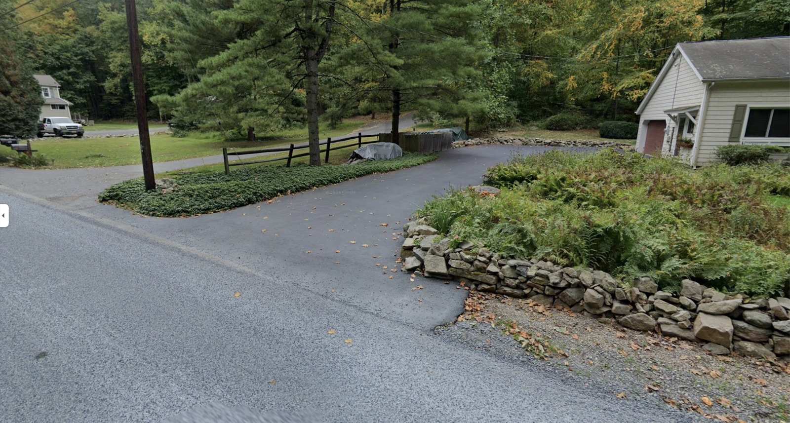 The driveway at 120 Rockaway Rd — park along the paved driveway leading up to the house.