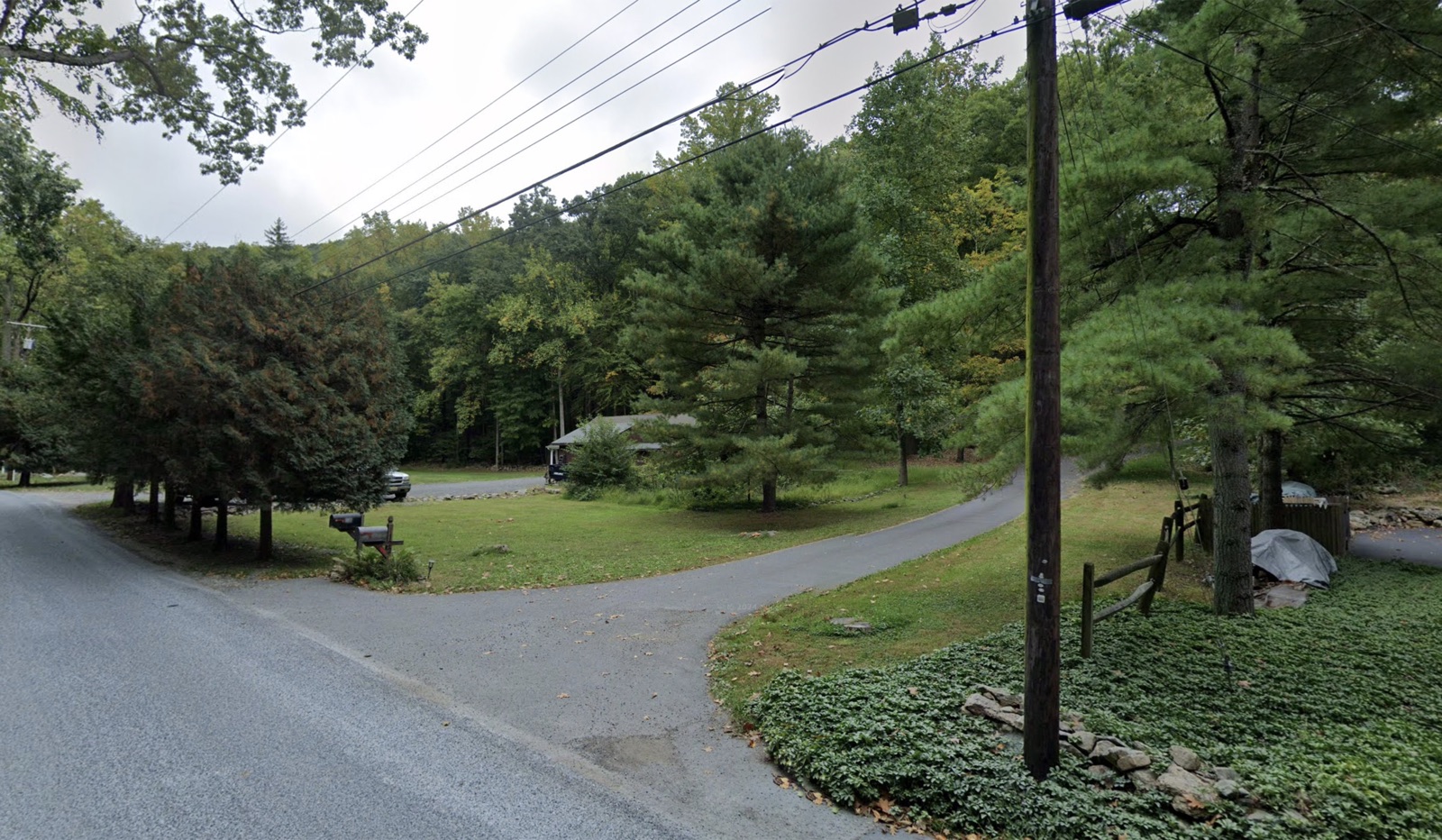 The neighbor's lawn used for overflow parking — park on the grass, not blocking the driveway.